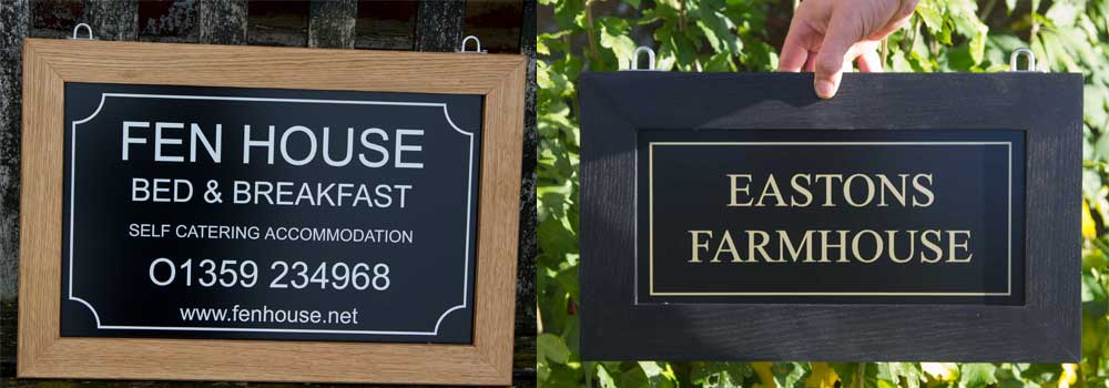 Framed hanging signs with cut vinyl lettering.